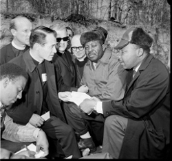 Four clergymen speaking to Dr. Martin Luther King jr and two unidentified men.