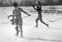 Children playing Hockey on a frozen pond, scoring a goal. Black and white still from Massecar film, 1947-1949, location unknown.