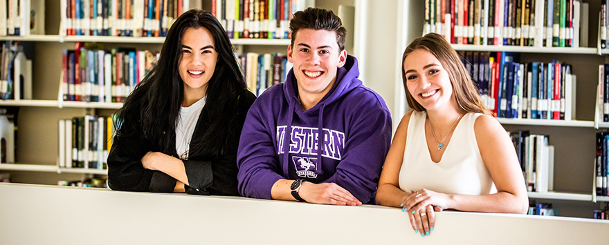 Three students in the Business Library