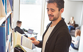 Student looking at a book