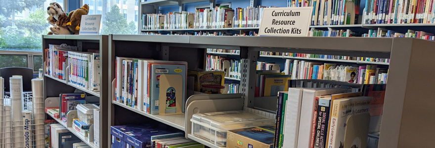 Books and Curriculum Resource Collection kits on shelves