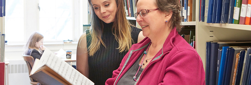 Staff member and a student looking at a musical score