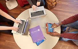 Overhead photo of students using laptops and tablets